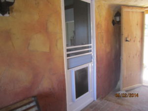 Pet Door on a White Colonial Swinging Screen Door